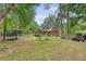 Large backyard featuring a swing set, trampoline, privacy fence, and the home's exterior and porch at 104 Leighton Ct, Summerville, SC 29485