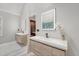 Well-lit bathroom showcasing double floating vanities, a walk-in shower, and private water closets at 104 Leighton Ct, Summerville, SC 29485