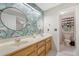 Stylish bathroom showcasing double sinks, tropical wallpaper, and a separate toilet area for added privacy at 104 Leighton Ct, Summerville, SC 29485
