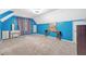 Spacious bedroom with a calming blue palette, showcasing ample space and natural light from the window at 104 Leighton Ct, Summerville, SC 29485