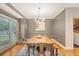 Elegant dining room with a large window, hardwood floors, stylish lighting, and modern decor at 104 Leighton Ct, Summerville, SC 29485