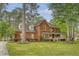 Charming two-story brick home with a spacious front yard, covered porch, and mature trees, offering classic curb appeal at 104 Leighton Ct, Summerville, SC 29485