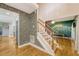 Inviting foyer featuring patterned wallpaper, hardwood floors, and a staircase to the upper level at 104 Leighton Ct, Summerville, SC 29485
