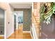 Elegant foyer with hardwood floors, stylish wallpaper, staircase, and open view to the bright living space at 104 Leighton Ct, Summerville, SC 29485