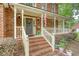 Inviting front porch with brick stairs, white railings, decorative wreath, and American flag waving proudly at 104 Leighton Ct, Summerville, SC 29485