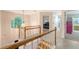 Bright hallway with wood railing, arched window, light fixture, and access to bedrooms and bathrooms at 104 Leighton Ct, Summerville, SC 29485