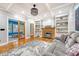 Well-lit living room featuring hardwood floors, a fireplace, and a seamless transition to an adjacent room at 104 Leighton Ct, Summerville, SC 29485