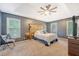 Spacious main bedroom with a tray ceiling, large windows, a ceiling fan, and soft carpet at 104 Leighton Ct, Summerville, SC 29485