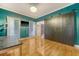 Charming office space features hardwood floors, a large window, and a rustic sliding barn door at 104 Leighton Ct, Summerville, SC 29485