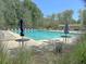 Community pool with umbrellas and tables for relaxation at 104 Leighton Ct, Summerville, SC 29485