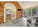 Enclosed porch with a brick accent wall, features comfortable seating and a view of the backyard at 104 Leighton Ct, Summerville, SC 29485