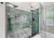 Modern glass enclosed shower with a rain showerhead and decorative tile at 104 Leighton Ct, Summerville, SC 29485