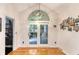 Sun room features a statement light fixture, arched window, and easy access to pantry at 104 Leighton Ct, Summerville, SC 29485