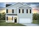 Charming two-story home featuring a garage, black shutters, and a well-maintained front yard at 1040 Forrest Creek Dr, Summerville, SC 29483
