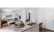 Open concept kitchen with stainless steel appliances and granite countertops blending into living and dining areas at 1048 Forrest Creek Dr, Summerville, SC 29483
