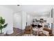 Open-concept living and dining area with white walls, wood floors, and modern furnishings at 1048 Forrest Creek Dr, Summerville, SC 29483