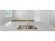Modern kitchen island sink featuring granite counters with view to backyard at 1050 Forrest Creek Dr, Summerville, SC 29483