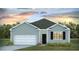 New construction, one-story home with a two-car garage and manicured lawn under cloudy skies at 1052 Forrest Creek Dr, Summerville, SC 29483