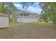 Backyard view featuring a gray house with a charming porch and spacious yard at 1224 Midvale Ave, Charleston, SC 29412