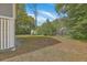 A serene backyard showing a storage shed, grass, and lush landscaping at 1224 Midvale Ave, Charleston, SC 29412