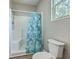 Bright bathroom featuring a shower with a decorative blue shower curtain at 1224 Midvale Ave, Charleston, SC 29412