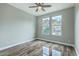 Cozy bedroom with wood floors, ceiling fan, and bright windows with a view at 1224 Midvale Ave, Charleston, SC 29412