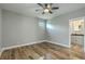 Spacious bedroom with hardwood floors, a ceiling fan, and an ensuite bathroom at 1224 Midvale Ave, Charleston, SC 29412