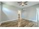 Bedroom with hardwood floors, ceiling fan, and access to an ensuite bathroom at 1224 Midvale Ave, Charleston, SC 29412