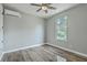 Bedroom featuring wood floors, a ceiling fan, a window, and a mini split system at 1224 Midvale Ave, Charleston, SC 29412