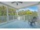 Relaxing outdoor deck with a ceiling fan, blue floorboards, and wooded views at 1224 Midvale Ave, Charleston, SC 29412