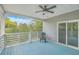 Relaxing outdoor deck with a ceiling fan, blue floorboards, and wooded views at 1224 Midvale Ave, Charleston, SC 29412