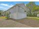 Exterior angled view of a gray home showcasing its siding and well-maintained yard at 1224 Midvale Ave, Charleston, SC 29412