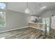 Modern open-concept kitchen with white cabinets, breakfast bar seating, and sleek countertops with pendant lighting at 1224 Midvale Ave, Charleston, SC 29412