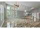 Open-concept living space filled with natural light, vaulted ceilings, sleek floors, and a modern kitchen at 1224 Midvale Ave, Charleston, SC 29412