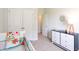 Bedroom with white crib, dresser, and a bright lamp; open door view into hallway at 124 Haventree Ct, Summerville, SC 29486