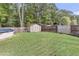 A spacious backyard with a storage shed, wood fence, above ground pool and grassy lawn at 1252 Wild Goose Trl, Summerville, SC 29483