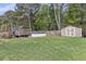 Large backyard with a shed, in-ground pool with a deck, mature trees and lawn area at 1252 Wild Goose Trl, Summerville, SC 29483