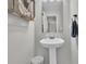 Powder room featuring a pedestal sink, decorative mirror, and stylish fixtures at 1252 Wild Goose Trl, Summerville, SC 29483