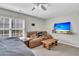 Bedroom features a bed, sofa, wooden coffee table, mounted television, and a ceiling fan with lighting at 1252 Wild Goose Trl, Summerville, SC 29483