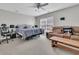 Bedroom features a bed, sofa, wooden coffee table, accent chair, and a ceiling fan with lighting at 1252 Wild Goose Trl, Summerville, SC 29483