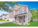 Charming two-story home featuring a landscaped front yard, cozy porch, and attached garage under a blue sky at 1252 Wild Goose Trl, Summerville, SC 29483