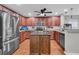 Modern kitchen featuring stainless steel appliances, an island with granite countertops, and ample cabinet space at 1252 Wild Goose Trl, Summerville, SC 29483