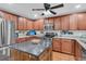 A view of a kitchen, including cabinets, appliances and a kitchen island with a gray countertop at 1252 Wild Goose Trl, Summerville, SC 29483