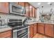 Close-up of the kitchen with stainless steel appliances and natural wood cabinetry at 1252 Wild Goose Trl, Summerville, SC 29483