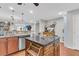A kitchen with a kitchen island, cabinets, stainless steel appliances, and a sink overlooking the living area at 1252 Wild Goose Trl, Summerville, SC 29483