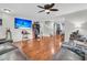 Spacious living room with hardwood floors, a ceiling fan, and a large TV for entertaining guests at 1252 Wild Goose Trl, Summerville, SC 29483