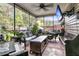 Covered patio with woven seating, plants, string lights, and a ceiling fan with a wall mounted TV at 1252 Wild Goose Trl, Summerville, SC 29483