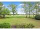 Scenic backyard view overlooking lush greenery and a serene golf course setting for peaceful outdoor enjoyment at 126 Balfour Dr, Charleston, SC 29492
