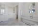 Elegant bathroom with a soaking tub, shuttered windows, and a vanity for a serene experience at 126 Balfour Dr, Charleston, SC 29492
