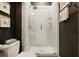 Modern bathroom showcasing a glass shower with patterned tile, dark walls, and a contemporary design at 126 Balfour Dr, Charleston, SC 29492